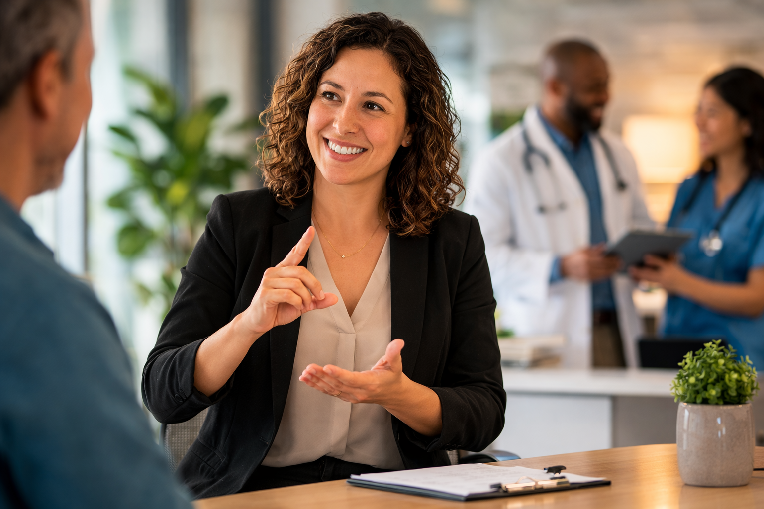 ASL interpreter signing during a medical appointment at a healthcare facility